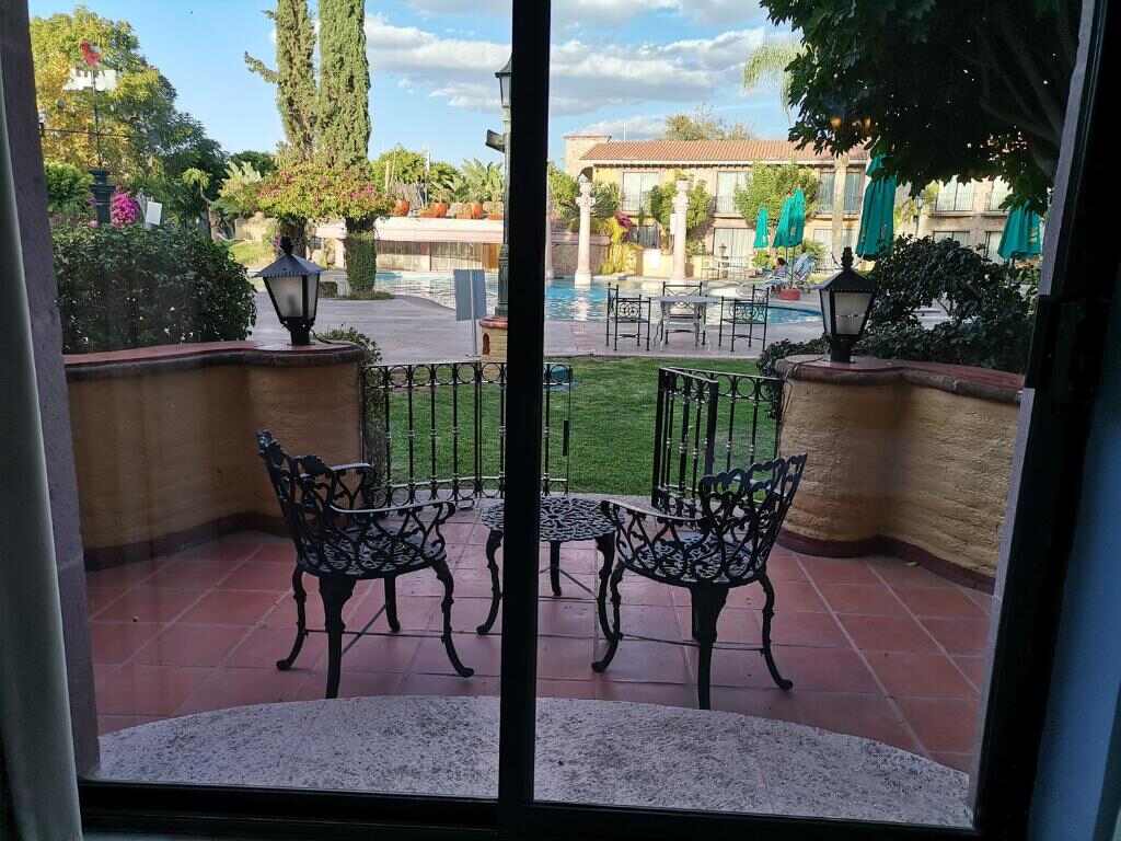 Balcony with view of the pool and gardens