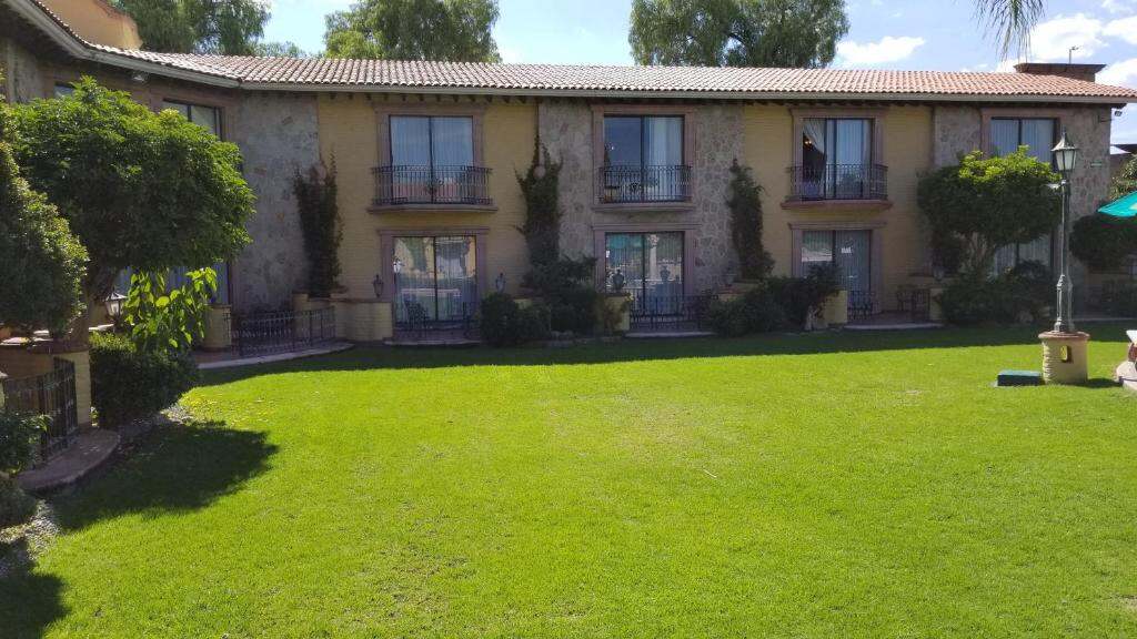 Lawn and hotel building with balconies